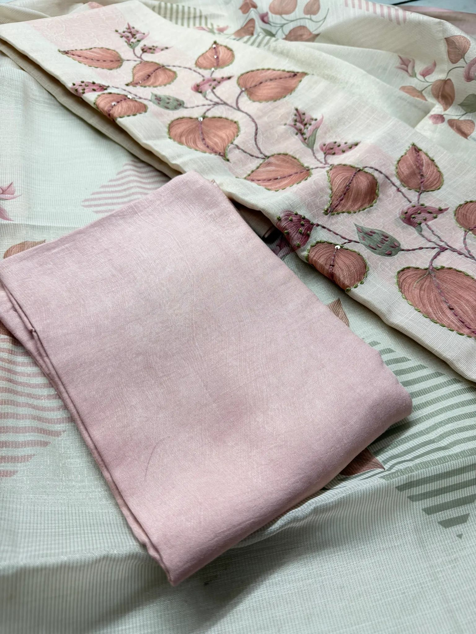 The blush bottom beside the dupatta, which carries the same vine in a lighter hand.