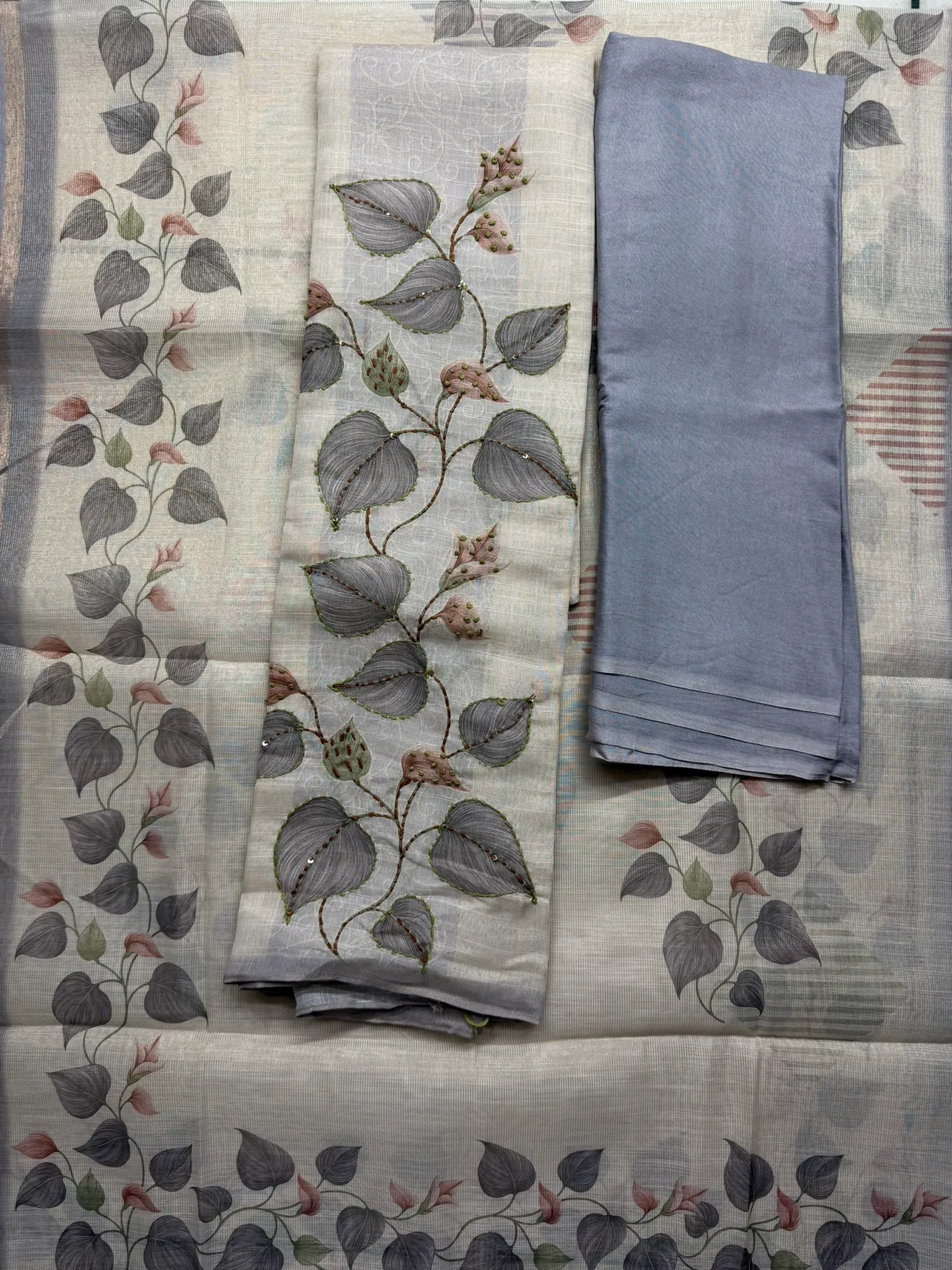 The dupatta and the grey bottom, the vine wandering along the borders.
