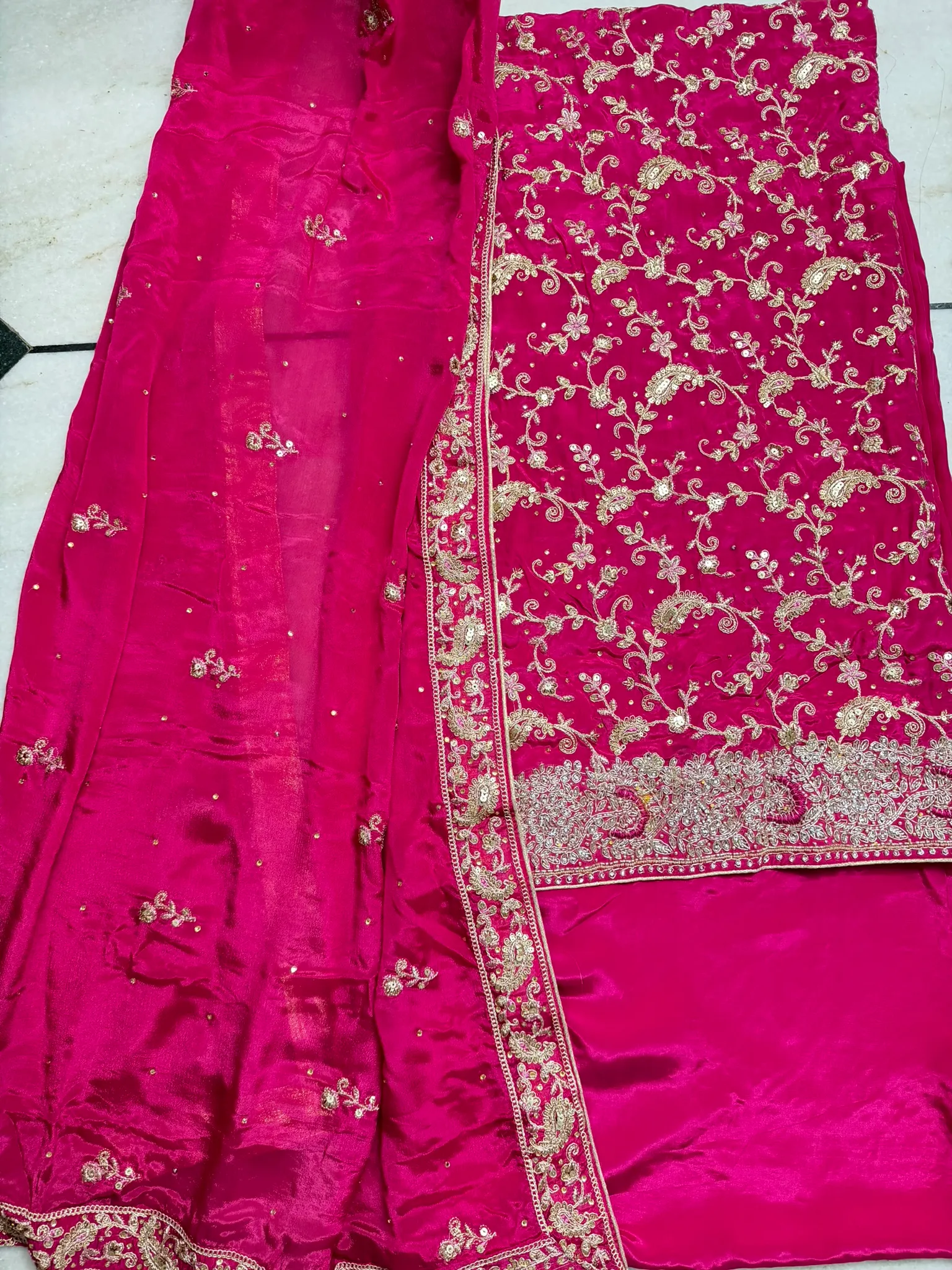 The set laid out — the gold-jaal kurta, its stone-set border, and the buti-scattered dupatta.