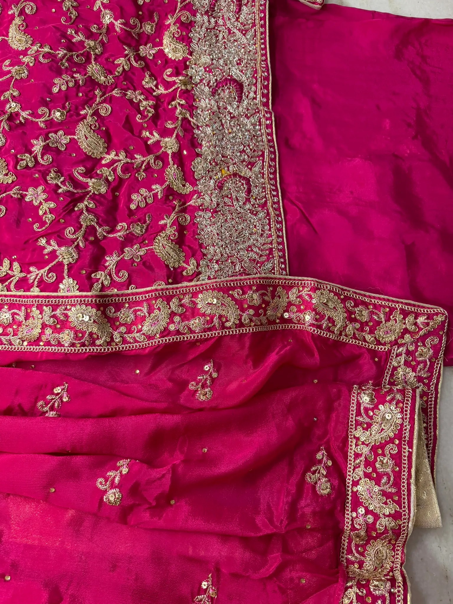 The dupatta, edged in the same gold and scattered with butis.
