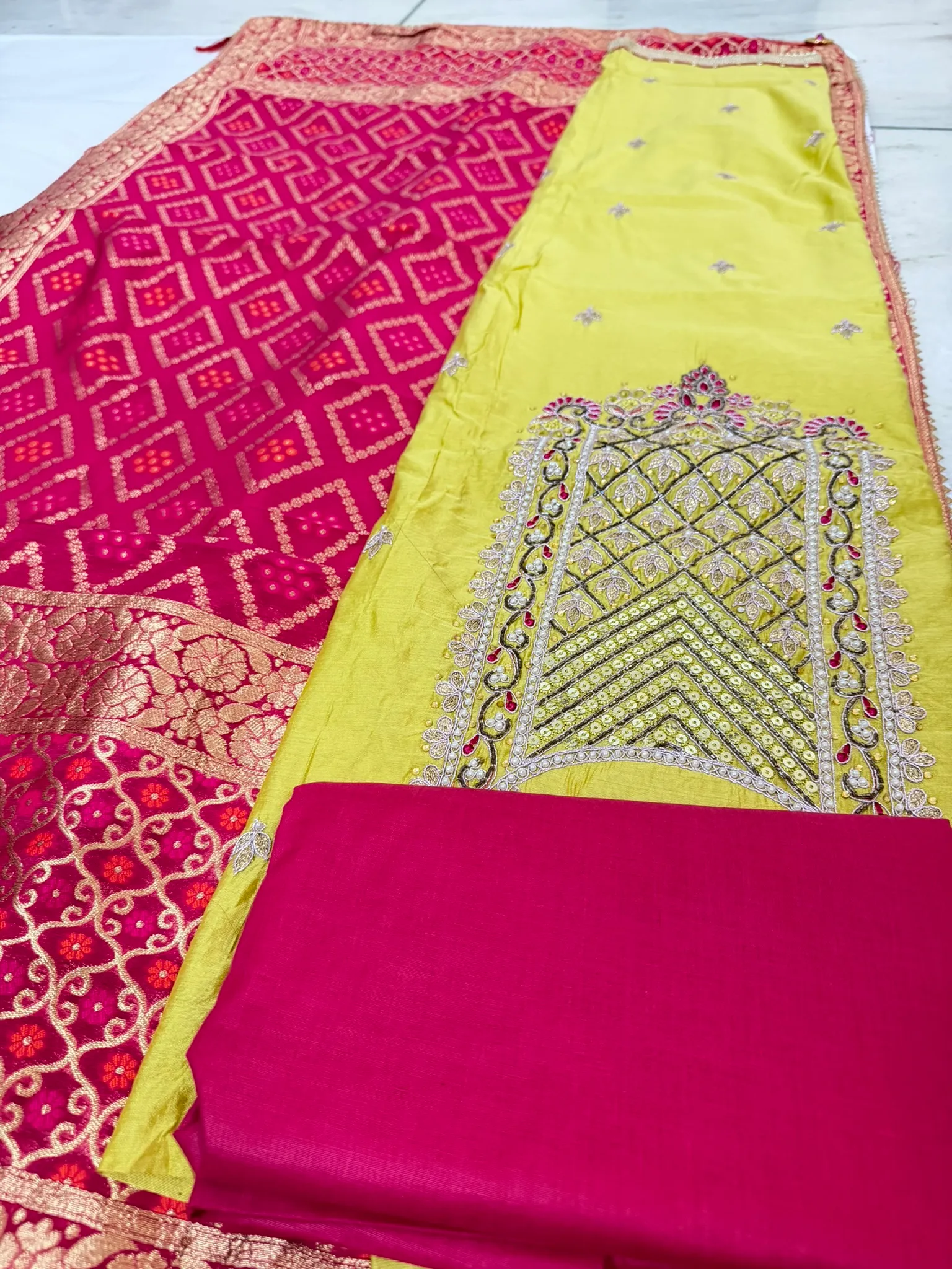 The dupatta: bandhani tie-dye through the body, woven Banarasi gold along the borders.